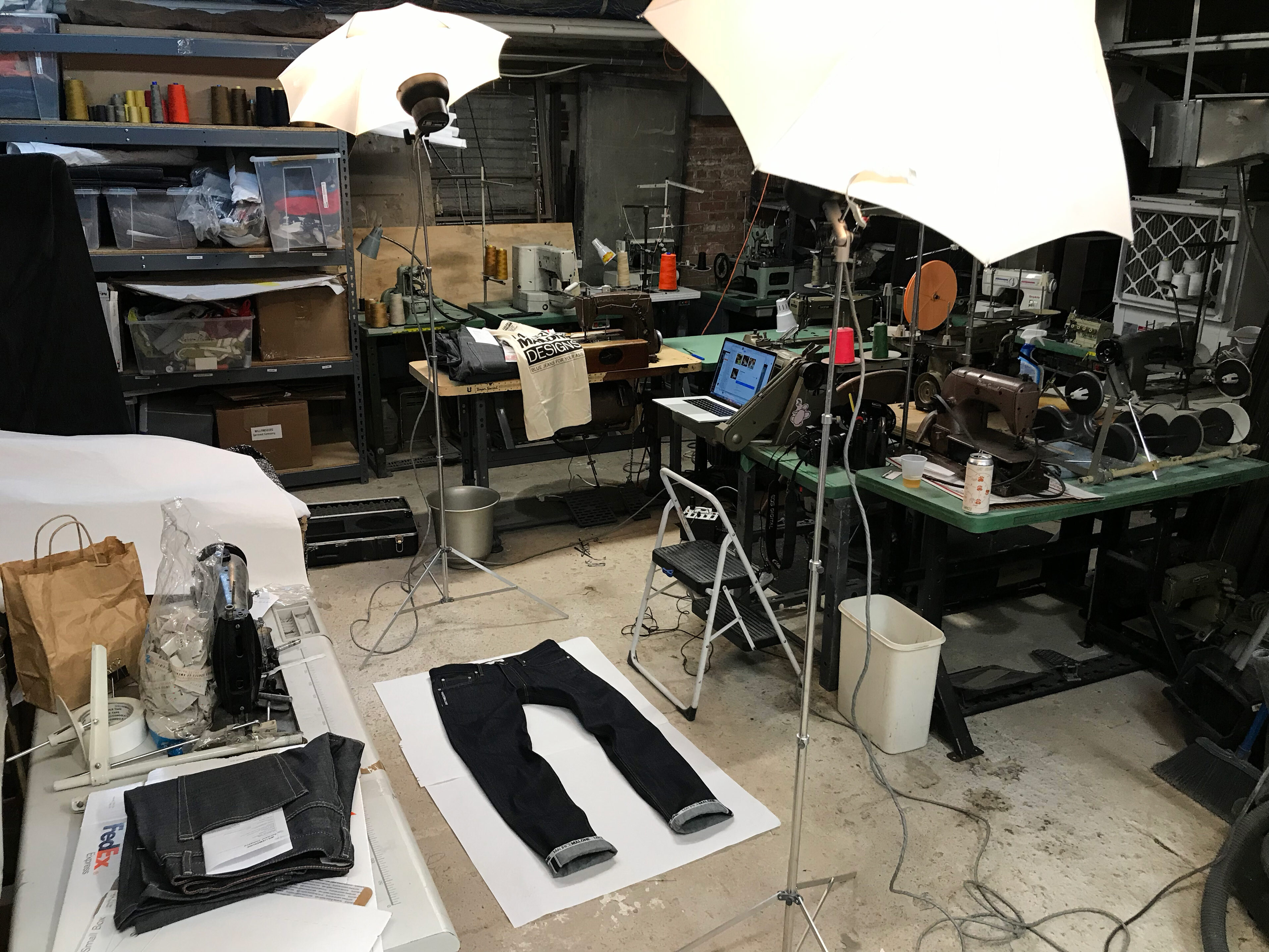 Williamsburg Garment Company workspace in the back office of Brooklyn Denim Company February 28 2019 showing sewing machines denim work area and photo setup.