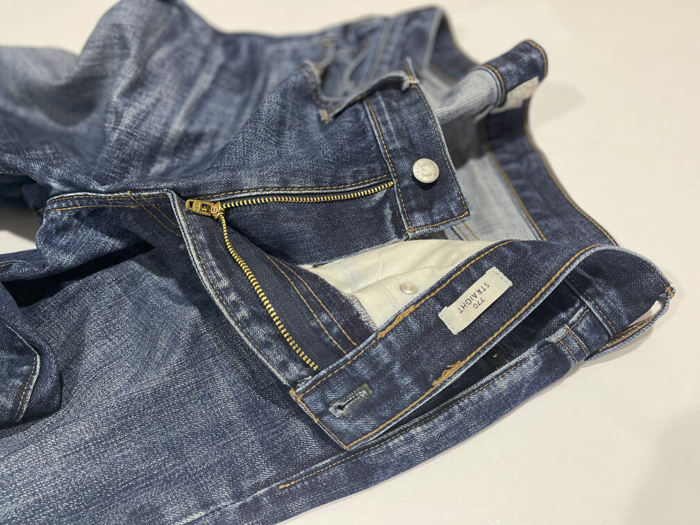 A look at the finished zipper repair on a pair of J. Crew 770 straight jeans with broken zipper teeth, after Williamsburg Garment Company fixed the jeans zipper. The only noticeable trace of new sewing is the joined stitching on the waistband's interior.