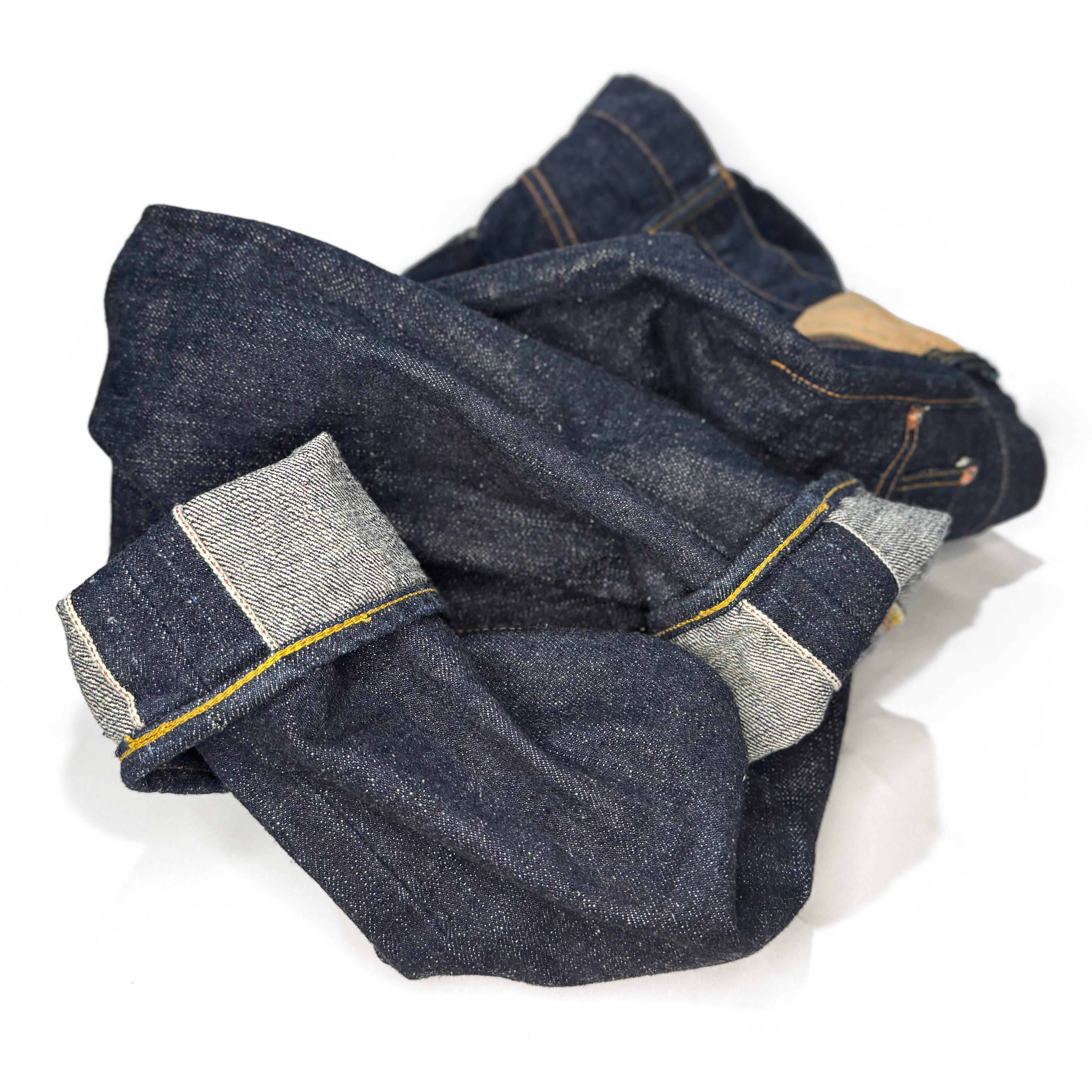 Outside view of a pair of selvedge jeans mishandled by another denim tailor who tapered the legs from the outseam instead of the inseam. Although the selvedge wasn’t cut off, the seam allowance was increased to shrink the leg, which distorted the selvedge line and compromised the jean’s construction.