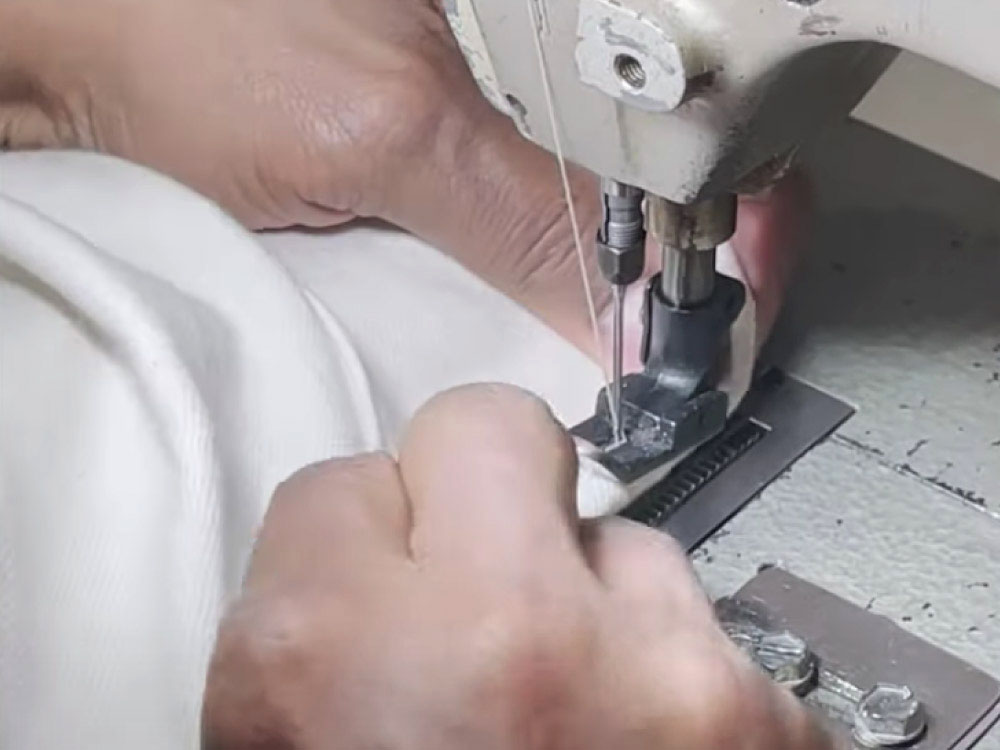 Chain stitch hemming a pair of jeans on a Union Special sewing machine.