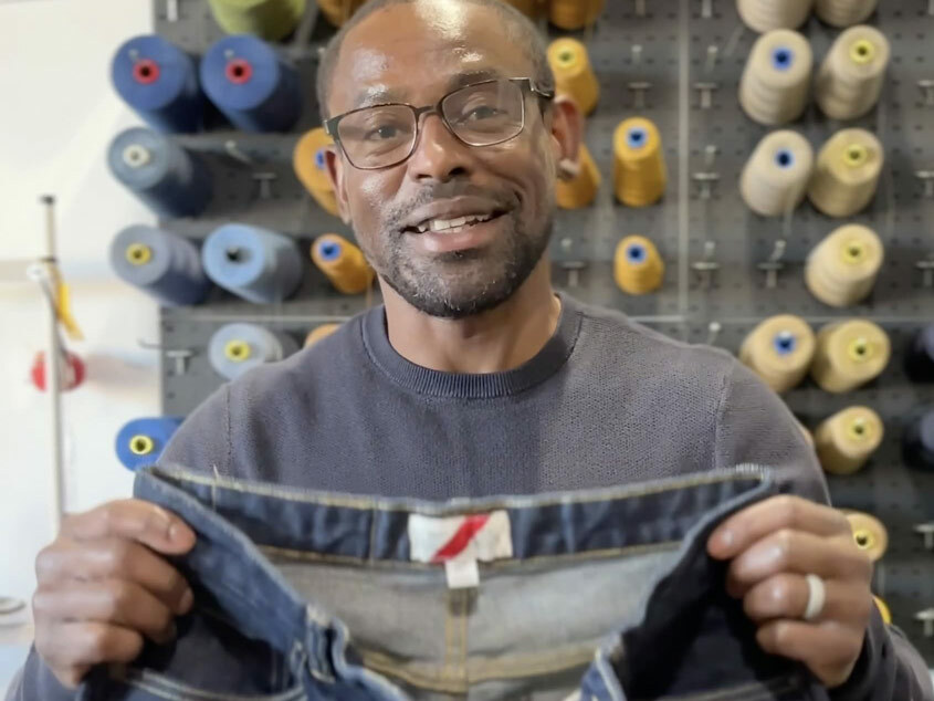 A still photo from Williamsburg Garment Company's TikTok denim video, which showcases an actual customer's experience with the same-day-while-you-wait chain stitch hemming service, was recorded in the denim brand's Greenpoint, Brooklyn, New York studio.