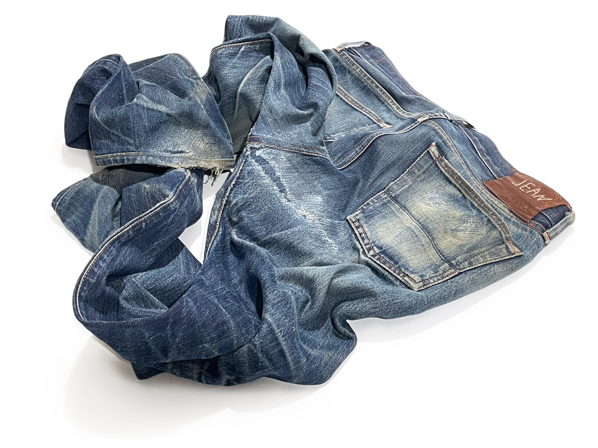 Crotch blowout, seat, hem, and pockets of a pair of Jean Shop jeans are mended with professional denim repair service by Williamsburg Garment Co., 