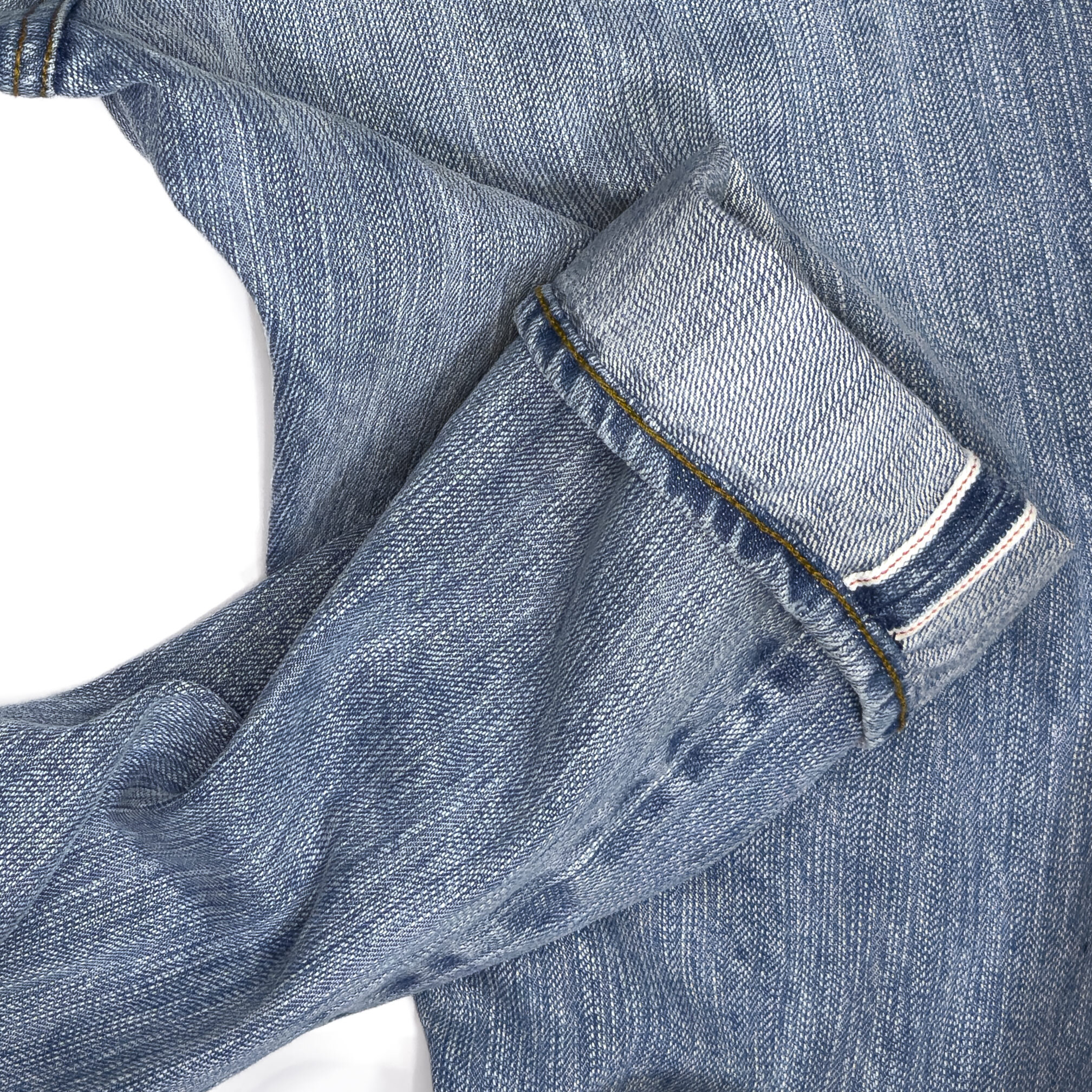 Close-up of Williamsburg Garment Company’s 15oz. light blue selvedge denim showing the textured weave and selvedge edge used in their custom-made jeans.