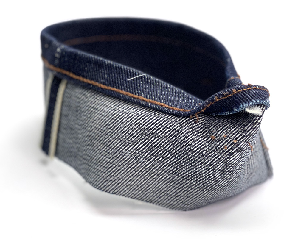 This is an example of what a fake chain stitch looks like on the cut-off hem from a 21-oz. heavyweight raw denim jean.