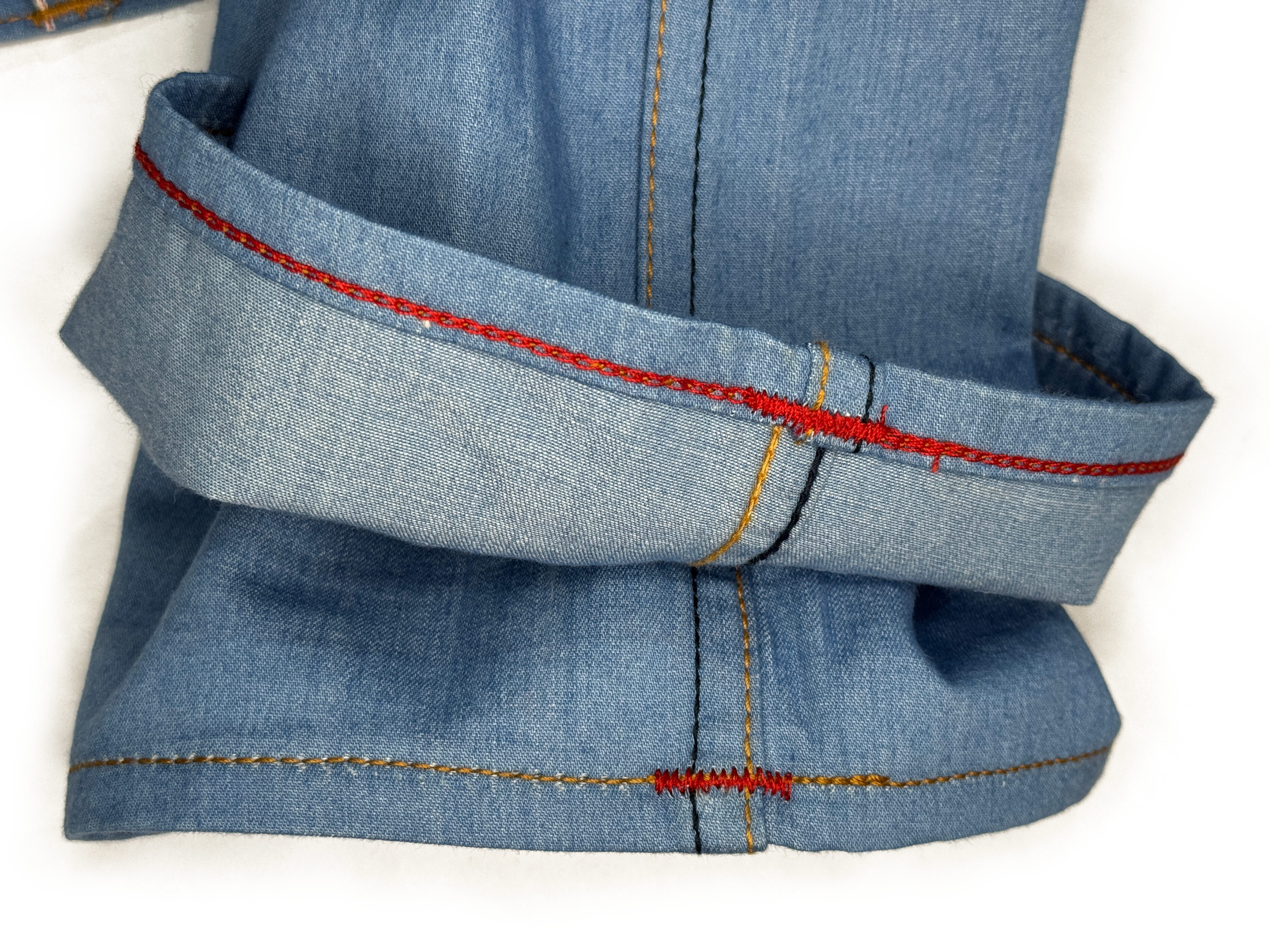 After hemming, a view of the red weft of Gustin jeans shows clean chain-stitching and properly sewn bar tacks on the inseam, sewn by Williamsburg Garment Company.