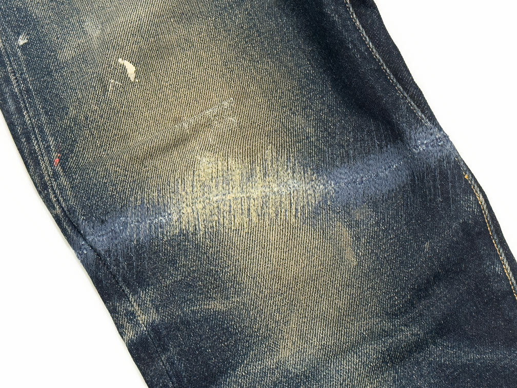 A close-up of ripped jeans expertly repaired by Williamsburg Garment Company demonstrates the sewing technique for reattaching the thigh and lower leg of Samurai Jeans that had been separated back together.