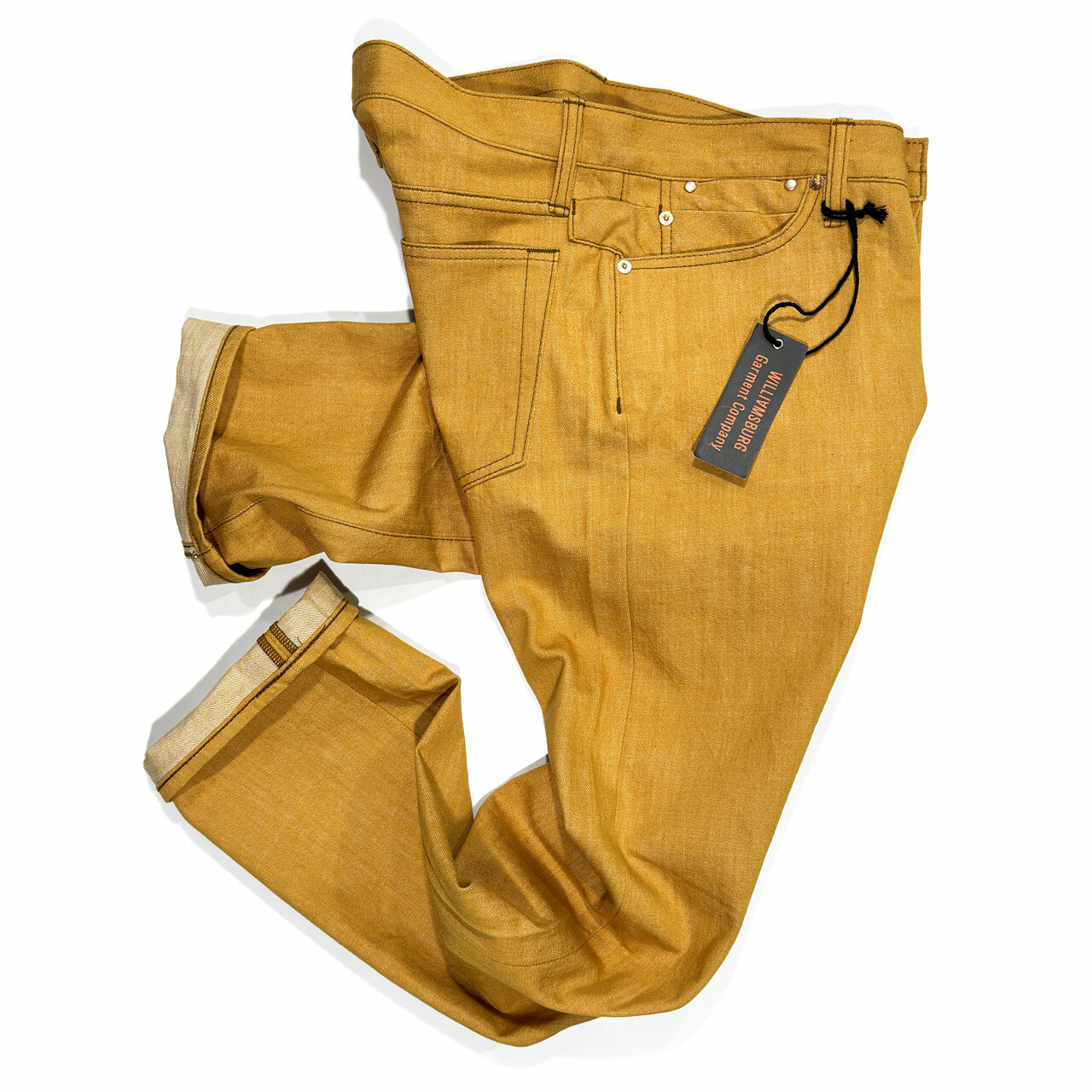 The side view of Williamsburg Garment Company men's straight-leg industrial yellow jeans made in the USA, crafted in Cone White Oak American-made denim.