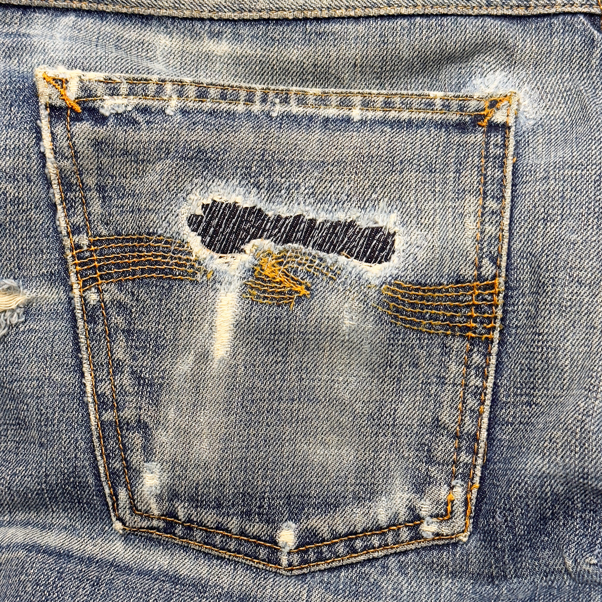Close-up of Nudie jean repair stitching by Williamsburg Garment Company on a whisker tear.
