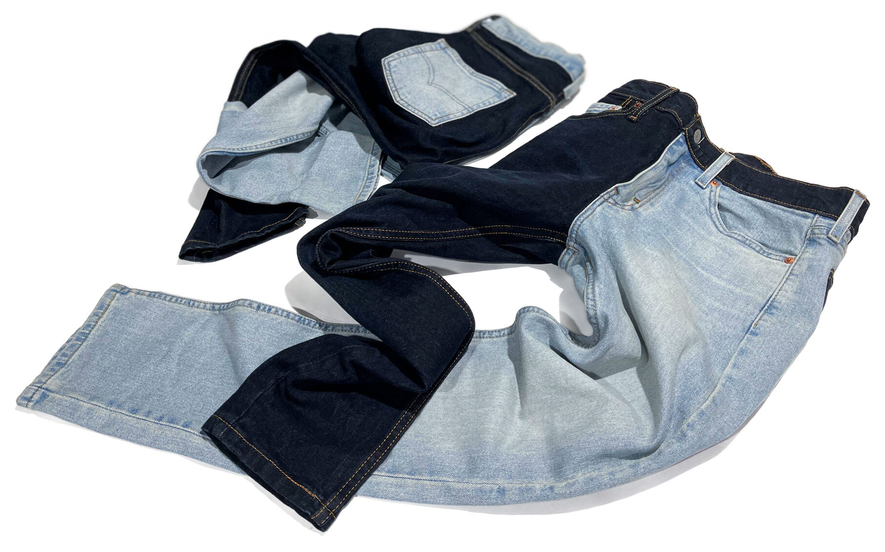 Two completed versions of men's customized Levi's jeans with contrast panels, custom-made by Williamsburg Garment Company from light and dark washed jeans by swapping parts.