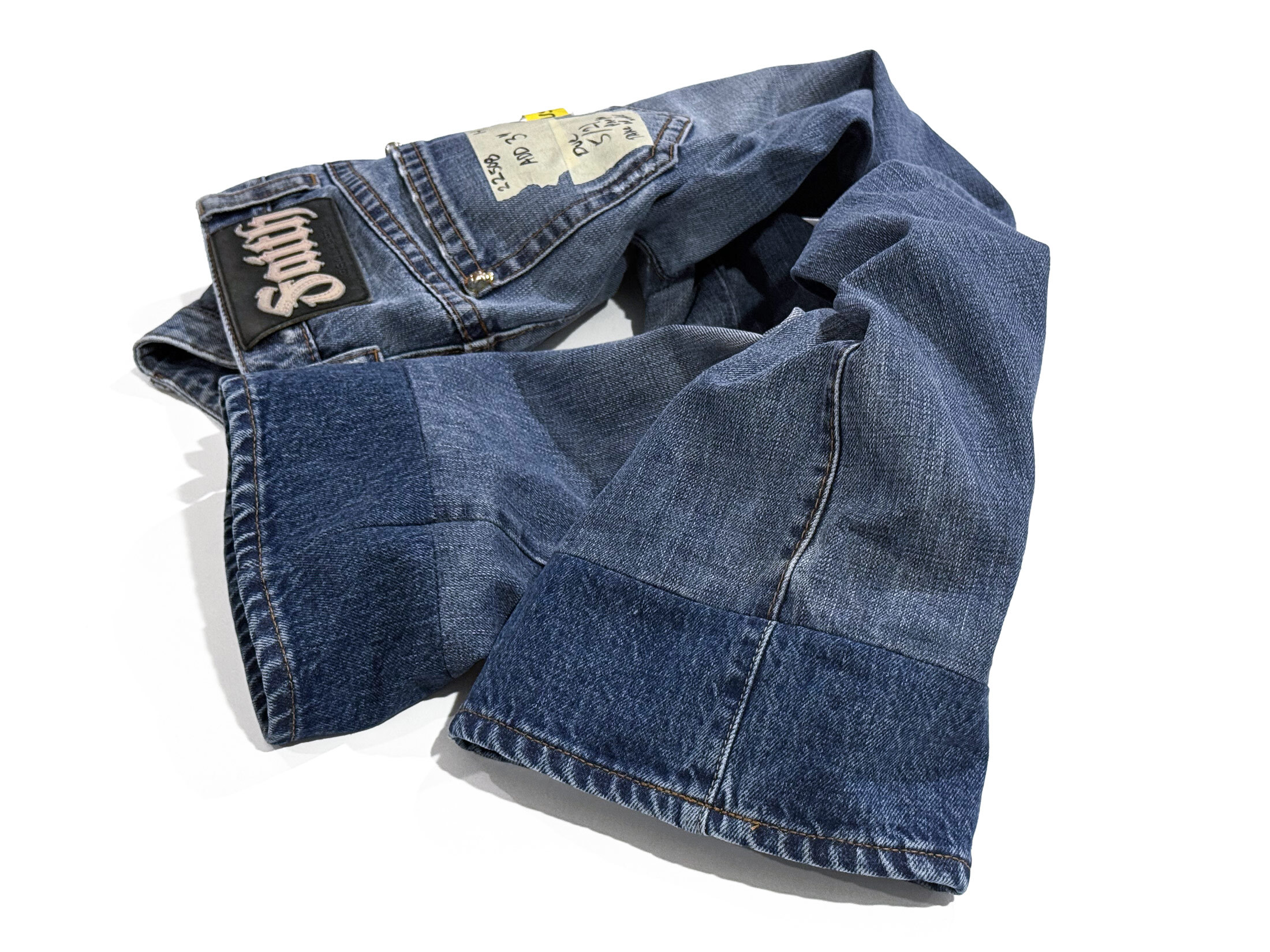 Vintage jeans with a professionally extended inseam using a slightly darker denim hem to add length with a clean contrast finish.