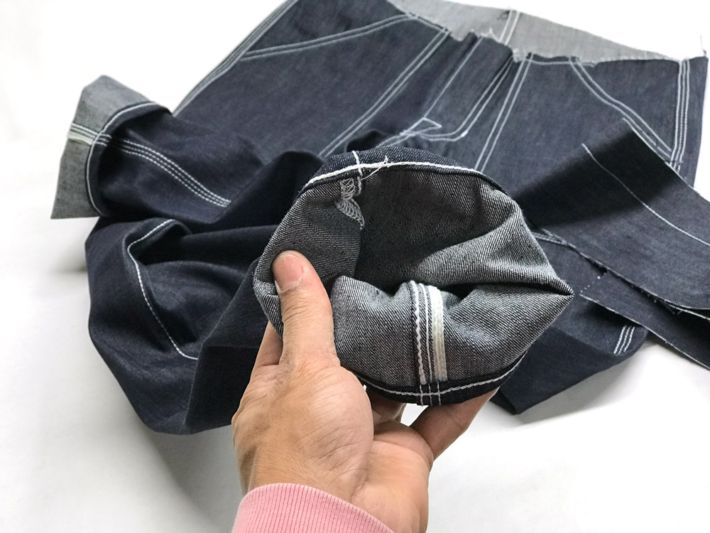 Close-up of handmade in Brooklyn 3-needle selvedge raw denim jeans Close-up of handmade in Brooklyn 3-needle selvedge raw denim jeans