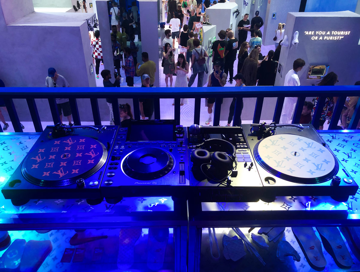 A view from the LV branded DJ booth looking over the show's floor inside the Louis Vuitton & Nike "Air Force 1" By Virgil Abloh Exhibition.