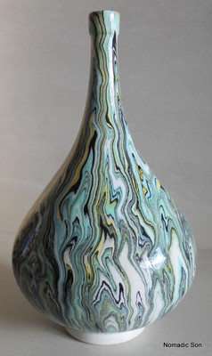 This incredible vase is a completely unique one off vase made by Elagoz (the only artist in the world to master Ebru on ceramics).  Sublime swirling patterns; a blend between the artist and the uncontrollable nature of Marbling.