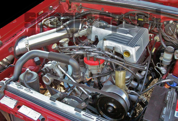 Scram Speed 79-93 SBF 5.0 302 Mustang Underdrive Power Steering Serpentine Pulley, installed in a car engine bay with visible belts and metal components. Scram Speed 79-93 SBF 5.0 302 Mustang Underdrive Power Steering Serpentine Pulley, installed in a car engine bay with visible belts and metal components.
