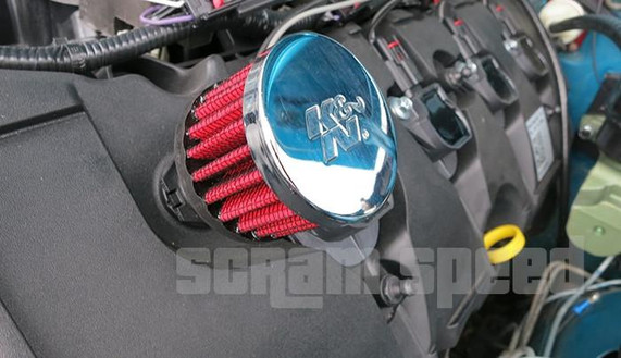 Scram Speed 5.0 DOHC Boss and Coyote Cam Cover Breather Kit, installed on a vehicle's engine with red filter and polished chrome cover, providing enhanced performance and engine protection.