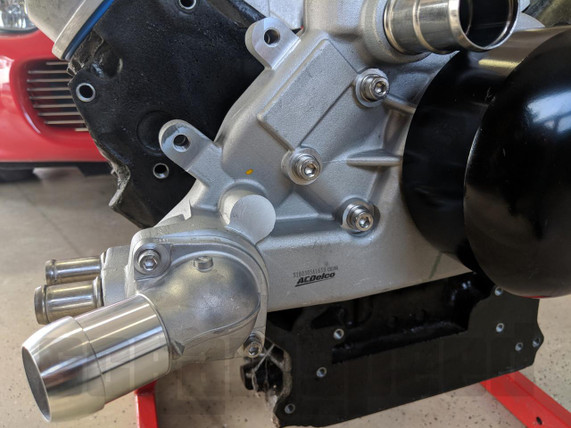 Scram Speed LSX Water Pump Bolts and Installation Kit - Stainless Steel, automotive water pump with stainless steel bolts and hardware attached to a car engine block.