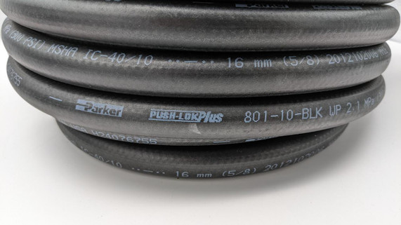 Fragola 870008 1/2 Inch Black Push Lock Hose, coiled black rubber hose with white text and specifications, suitable for industrial and hydraulic applications. Fragola 870008 1/2 Inch Black Push Lock Hose, coiled black rubber hose with white text and specifications, suitable for industrial and hydraulic applications.