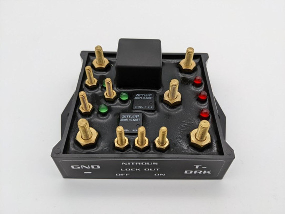 Scram Speed Single Stage Nitrous Relay Board, black metal and gold colored bolts with LED indicator lights.