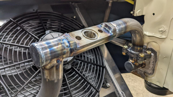 Scram Speed Quick Disconnect 1.75 Tube Chassis Flanges, NHRA Approved, showcasing a metallic tubular chassis flange connected to a racing vehicle's engine or exhaust system.