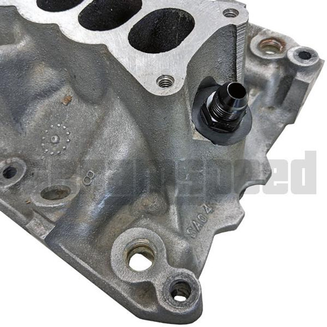Scram Speed Ford 5.0 Mustang -6AN PCV Catch Can Fitting, close-up of the fitting installed on an engine component with detailed metal surface and mounting points Scram Speed Ford 5.0 Mustang -6AN PCV Catch Can Fitting, close-up of the fitting installed on an engine component with detailed metal surface and mounting points