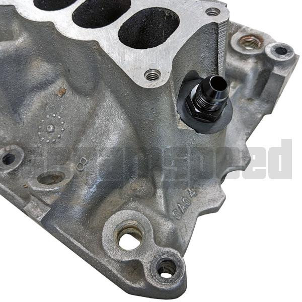 Scram Speed Ford 5.0 Mustang -8AN PCV Catch Can Fitting, automotive engine part attached to a cylinder head with black fitting installed.