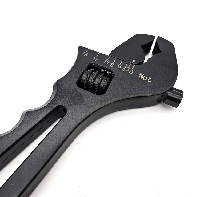 Scram Speed Adjustable AN Wrench, black adjustable wrench with measurement scale and rotating gear for precise tightening. Scram Speed Adjustable AN Wrench, black adjustable wrench with measurement scale and rotating gear for precise tightening.