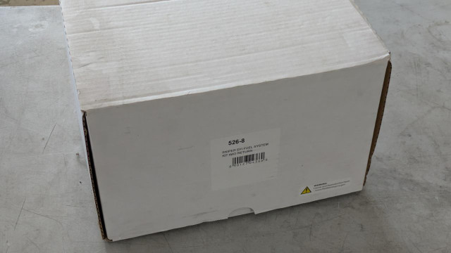 Holley Performance Parts – EFI, Intakes, & More Holley 526-8 Fuel System Pump Kit, close-up of the white cardboard box with product label and barcode on a concrete surface.