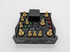 Scram Speed Single Stage Nitrous Relay Board, black metal and gold colored bolts with LED indicator lights.