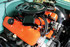 Holley Performance Parts – EFI, Intakes, & More Holley LS Coil Covers - Composite, close-up view of a high-performance car engine with vibrant orange valve covers and black coil covers.