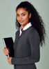 A woman with curly hair wearing a grey 2-way zip cardigan, holding a notebook. The cardigan features a fitted design.