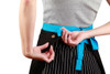 A black canvas short waist apron with a bright blue tie, featuring a branded logo on the side.