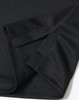 A close-up of a black sustainable jacquard knit polo shirt showcasing the fabric and sleeve design.
