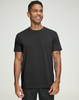 A men's premium cotton short sleeve tee shirt in black, featuring a logo on the chest, worn by a smiling model.