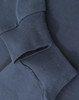 A close-up of navy blue cotton long sleeve tee shirt cuffs, featuring a subtle logo.