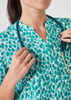 A turquoise tunic featuring a starlit print, with a collar and button detailing, paired with a stethoscope.