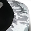 A trucker cap featuring a snow camouflage pattern in shades of grey, with a black mesh back and a branded logo.