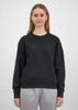 A black women's crew sweatshirt is displayed on a model, featuring a relaxed fit and long sleeves.