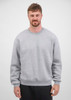 A men's crew sweatshirt in grey, featuring long sleeves and a classic fit, displayed by a model.