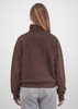A brown 1/4 zip jumper with a relaxed fit, featuring a high collar and long sleeves. Grey pants are worn with it.