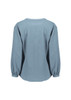 A women's long sleeve blouse in light blue, featuring a ruché design and a relaxed fit. It has a logo on the back.