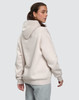 A unisex oversized hoodie in a soft cream colour, featuring a spacious hood and a relaxed fit.