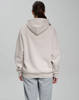 An oversized unisex hoodie in a light beige colour, featuring a spacious hood, shown from the back.