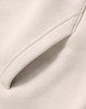 A close-up of a cream-coloured premium fleece oversized hoodie featuring a side seam pocket.