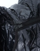 A black lightweight hooded puffer jacket featuring a zipper and a smooth interior lining. It has a branding logo visible.