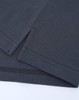 A close-up of a dark grey cotton/poly pique polo shirt, featuring seams and a small side split.