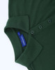 A green ladies' cotton/poly pique short-sleeve polo featuring a collar and button placket. It has a brand label.