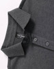 A dark grey ultrafine cotton pique polo with a two-button placket and folded collar. It features a logo on the label.