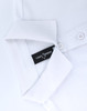 A white ultrafine cotton pique polo with a folded collar and a branding label visible inside.