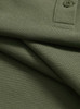 A close-up of an olive green ultrafine cotton pique polo shirt featuring a button and textured fabric.