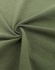 A close-up of a green fabric, showcasing its texture and softness, with a circular twist pattern.